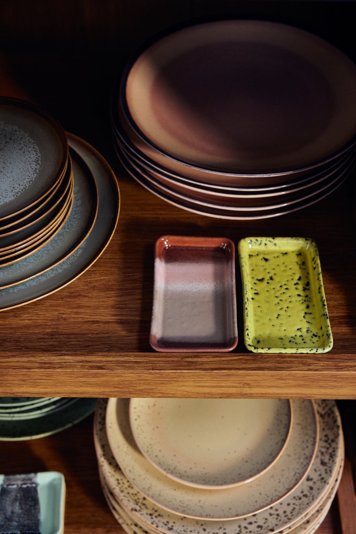 HKLIVING 70s Ceramics yellow corn trinket dish next to plum dish on wooden shelf, with stacked plates behind