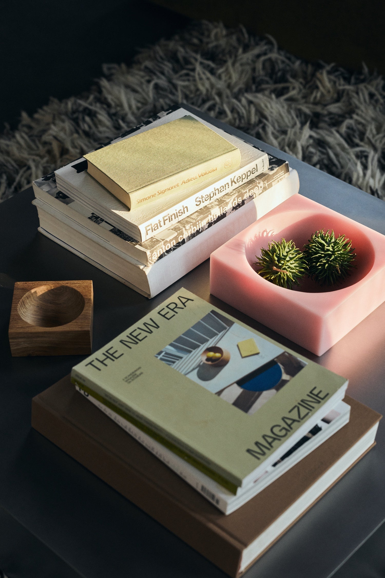 HKLIVING Pop Cube Large in Pink on a dark coffee table alongside stacked books and a small wooden bowl