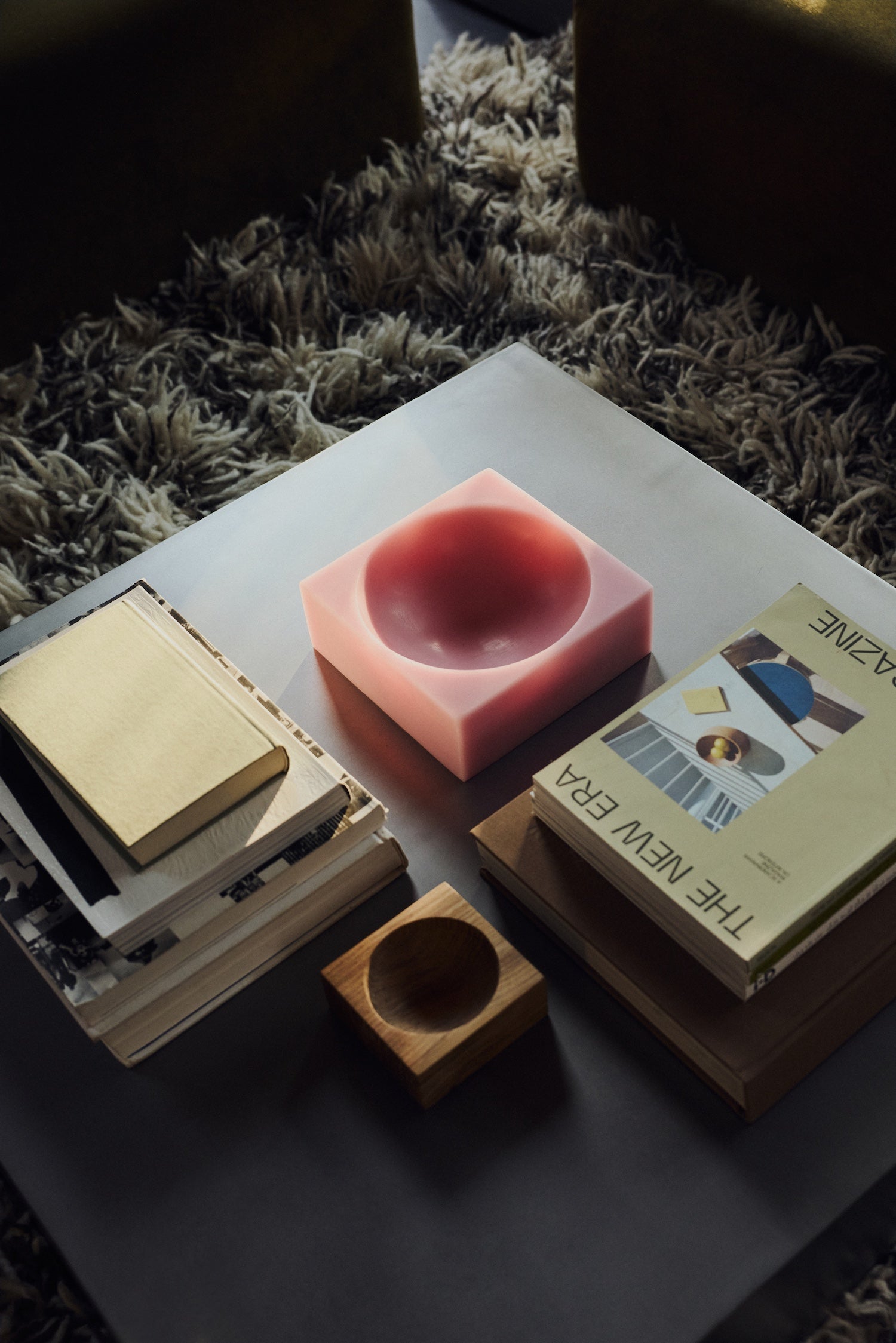 HKLIVING Pop Cube Large in Pink on a coffee table alongside stacked books and a magazine on a shag rug