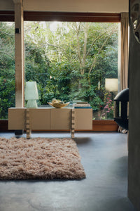 HKLIVING Glassfibre Table Lamp in Petrol Blue styled on a sideboard in a bright living room with garden view