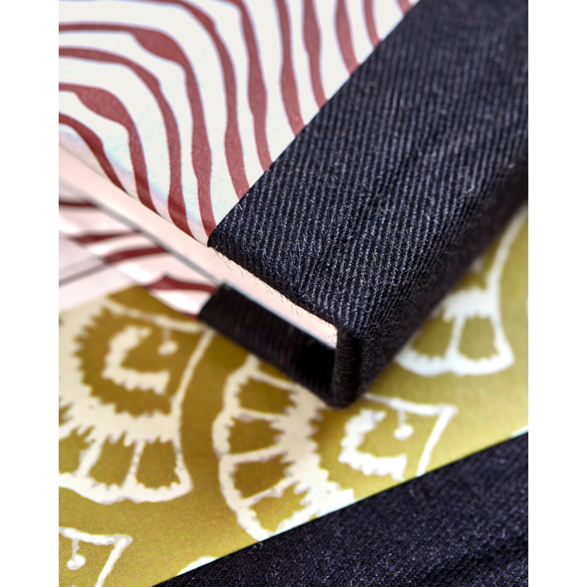 Close-up of notebook spines with cotton binding