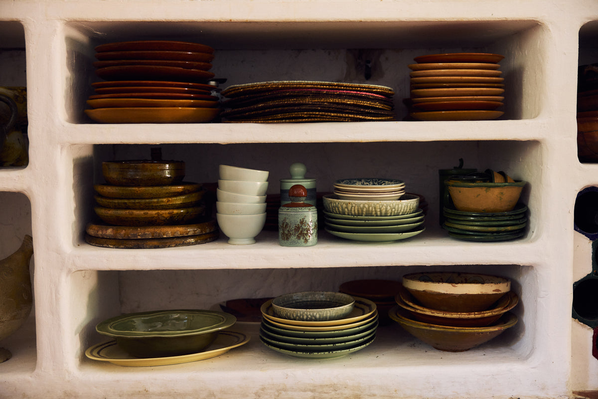 Whitewashed shelving stacked with HKLIVING Chef Ceramics plates and bowls
