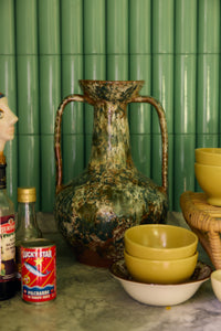 Robust Amphora Vase, Barn by HKLIVING styled on a kitchen counter in front of green tiles, alongside mustard-yellow bowls and pantry items