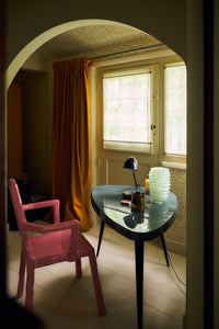 Ribble Glass Vase in Mint by HKLIVING styled on a side table with a black table lamp in a warm, colourful living room