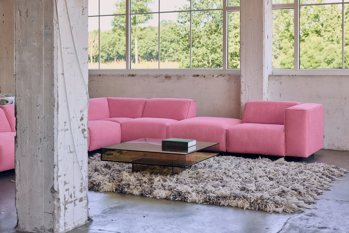 HKLIVING Acrylic Coffee Table in olive on a shaggy wool rug in front of a pink sofa in an industrial-style space