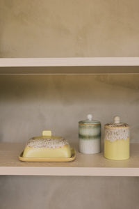 70s Ceramics storage jar in Custard styled on a shelf alongside a matching butter dish and another 70s ceramics storage jar