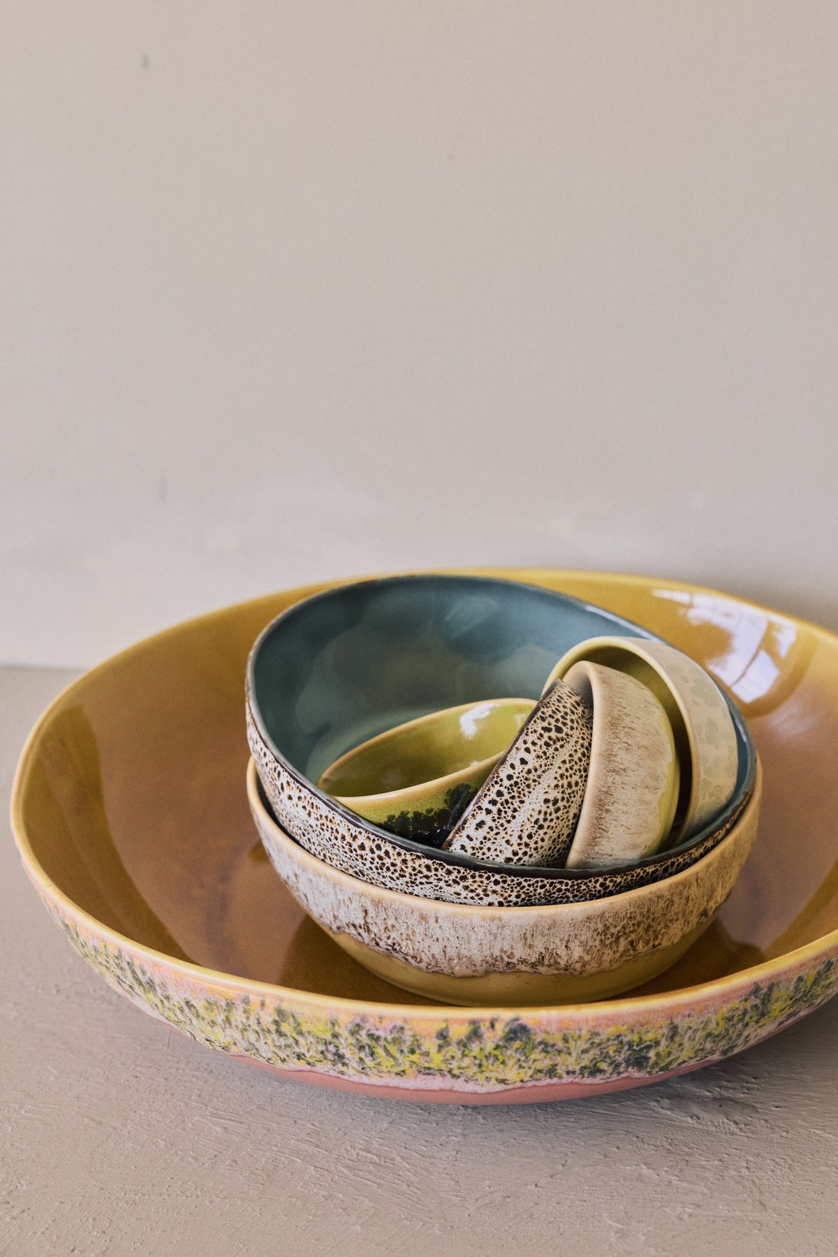 70s Ceramics pitcher, cups and pasta bowls in Brew displayed together on a shelf