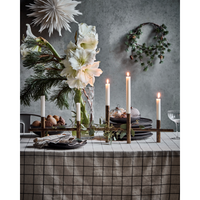 long antique brass candle holder styled on festive dining table with tall taper candles