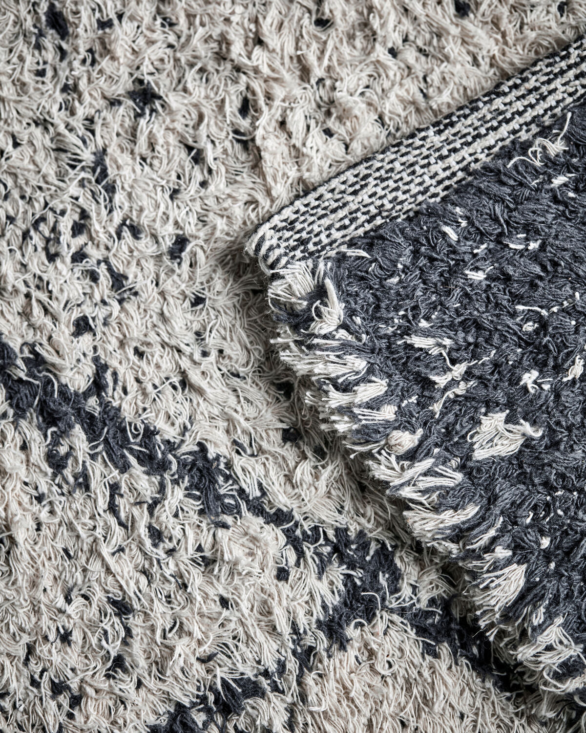 Close-up of House Doctor Cruz rug showing shaggy pile texture and both colourways
