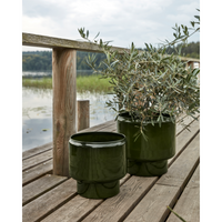 Set of 2 green iron planters from House Doctor on a wooden deck