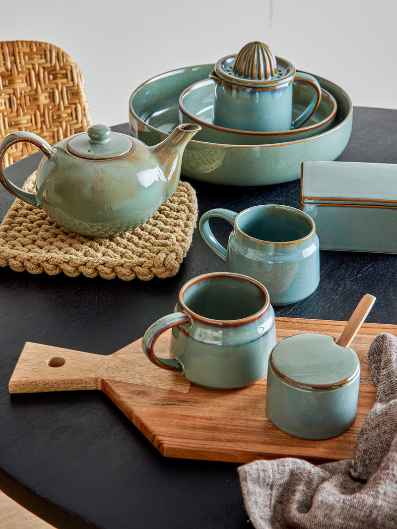 pixie jar with lid and spoon styled with matching green stoneware mugs and tea set