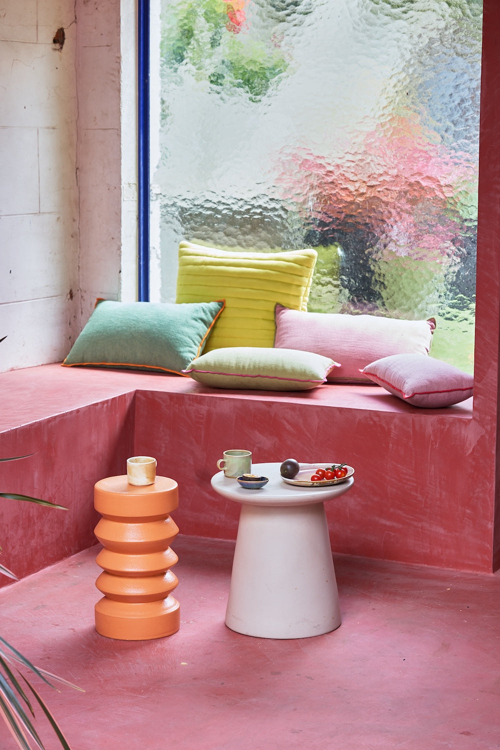 Terra stoneware side table by HKLIVING styled in a colourful window nook with cushions