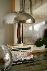 close-up of the HKLIVING logo, foot switch and cable outlet on the base of the chrome lounge table lamp