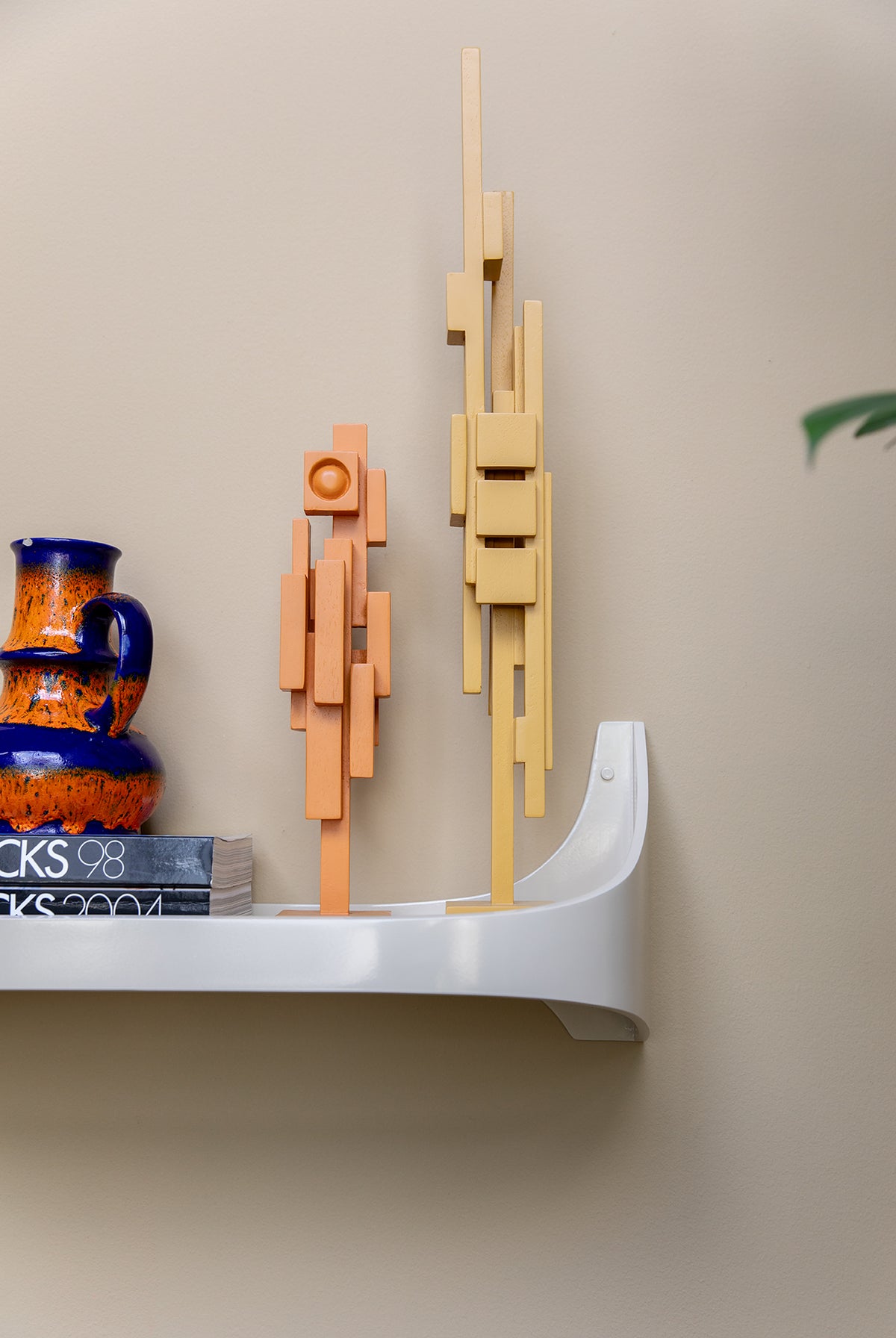 Lifestyle shot of the cream Retro Wall Shelf by HKLIVING styled in a showroom setting