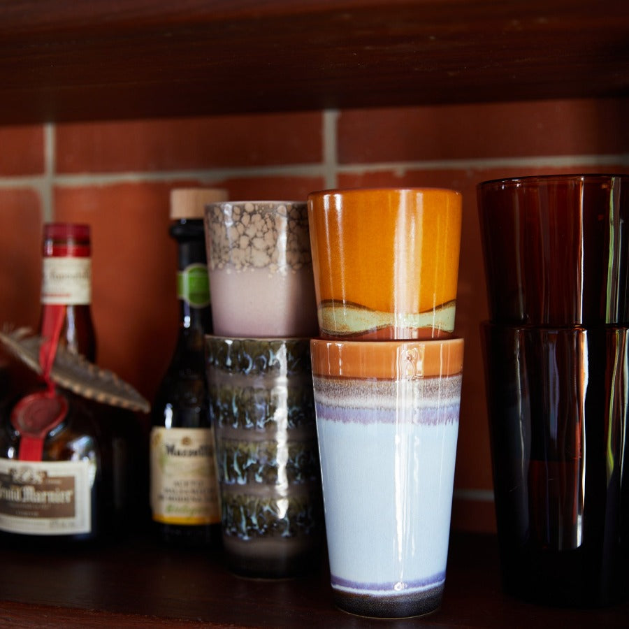 double stacked latte mugs and glasses on shelf in kitchen in bright colourful 70s styles form hkliving