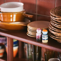 hkliving crockery stacked on shelves in a kitchen in bright 70s colours