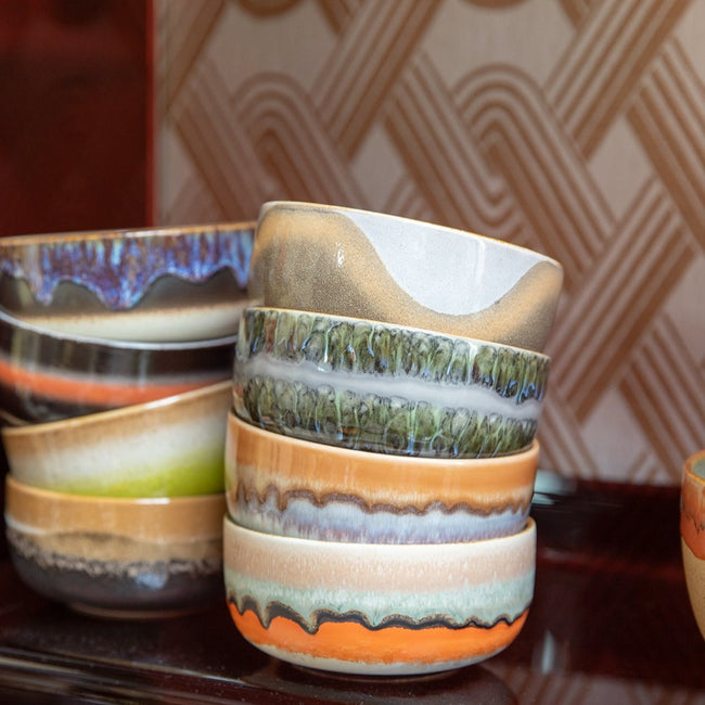 double stacked 70s coloured hkliving dessert bowls on a dark brown wooden side board