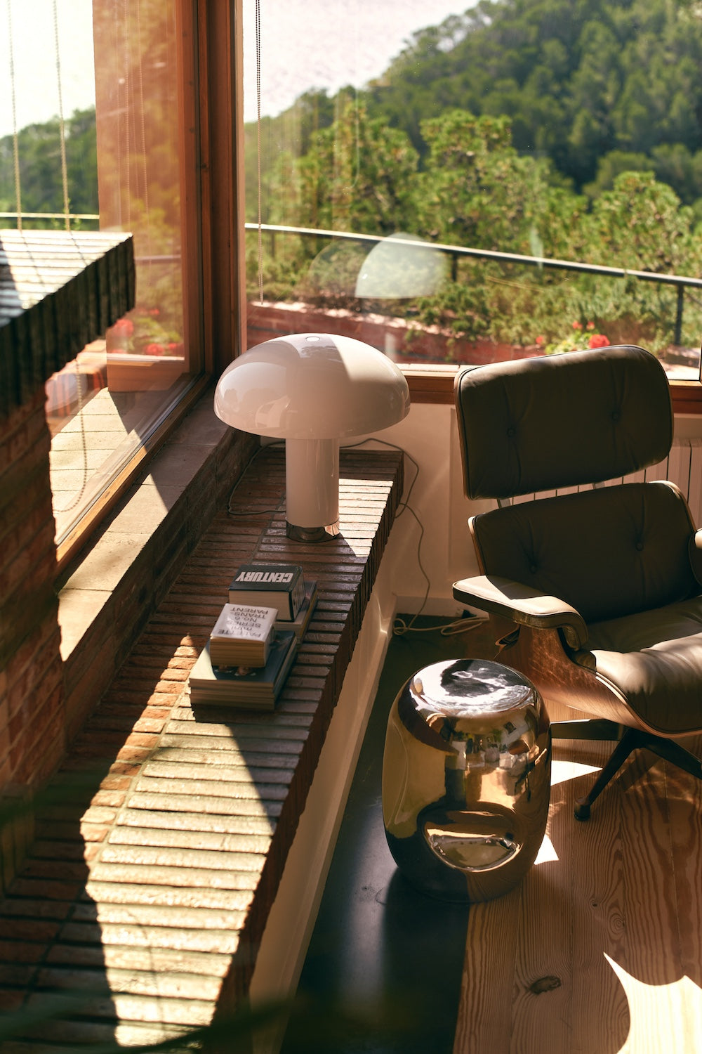 HKLIVING cream lounge table lamp on a brick window bench beside a leather armchair and gold side table, overlooking trees