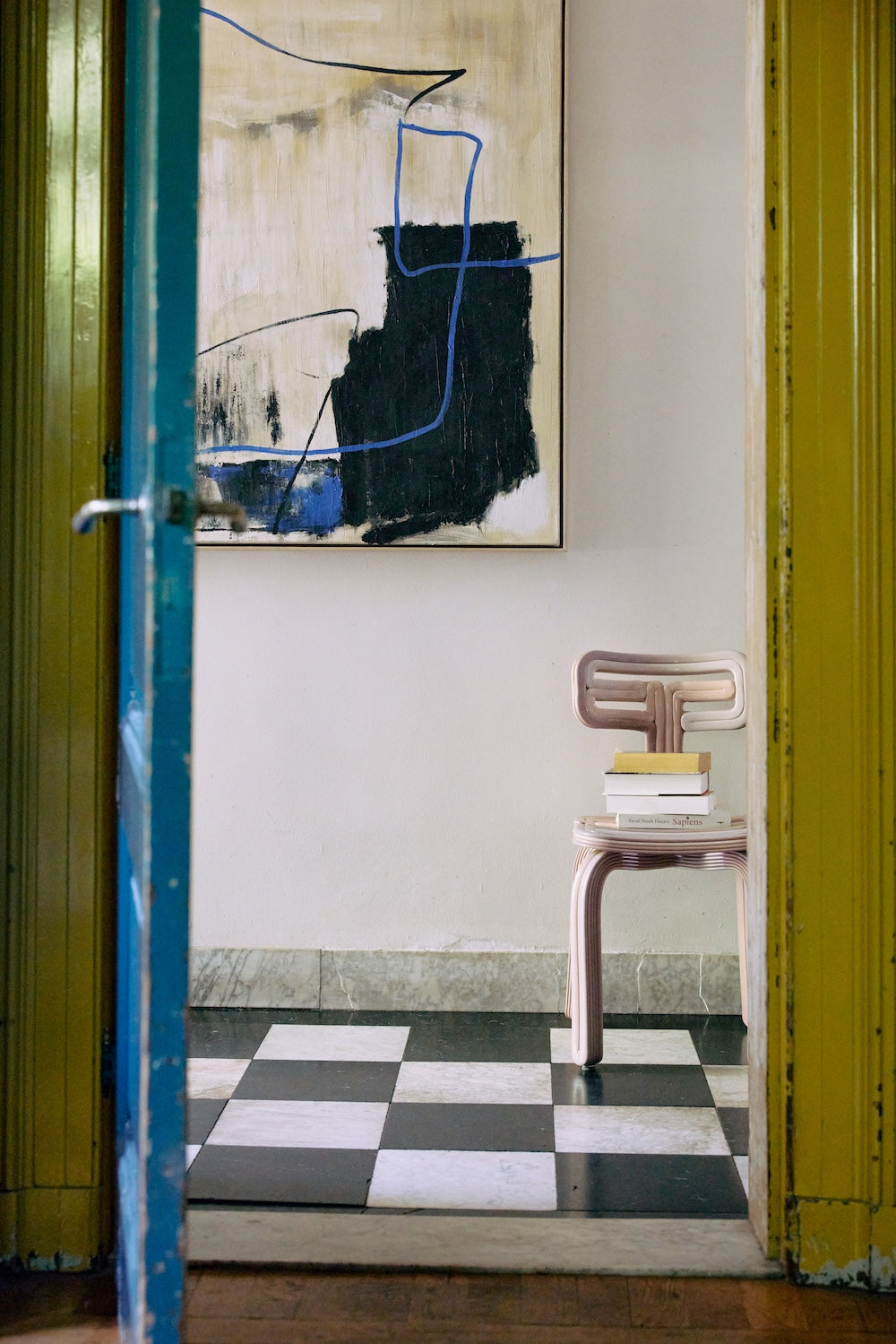 Easy Elan framed artwork by HKLIVING hung in a doorway above a pink side table