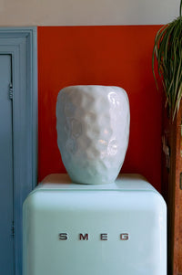HKLIVING pale mint earthenware floor vase styled on a mint Smeg fridge against a red wall