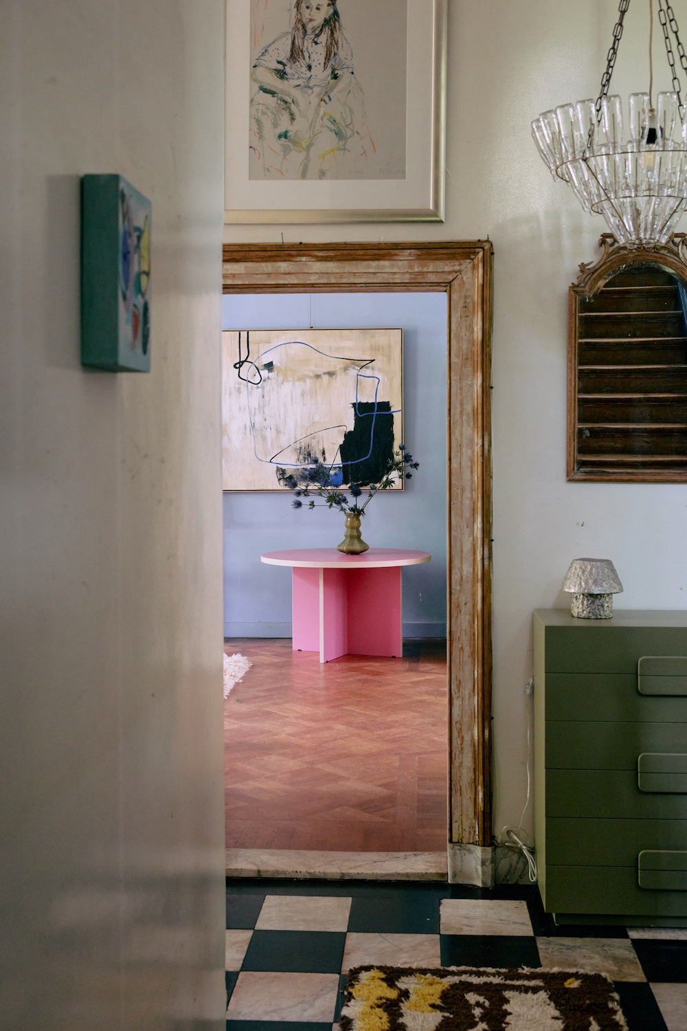 Easy Elan framed artwork by HKLIVING seen through a doorway above a pink table with flowers