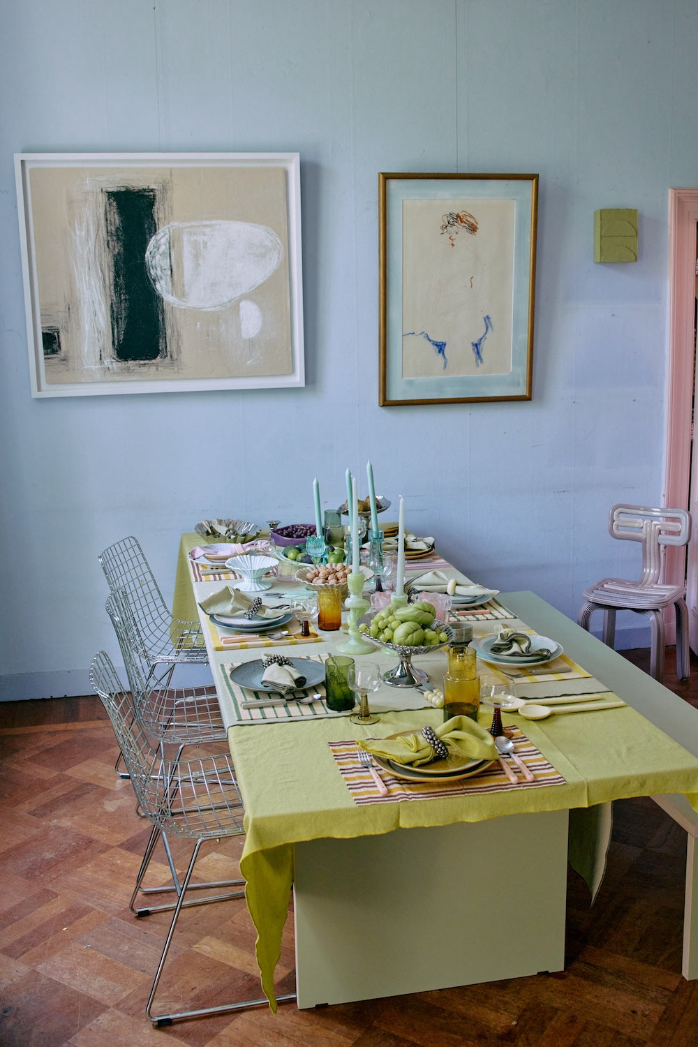 Offset framed artwork by HKLIVING hung above a table setting styled in green and yellow tones