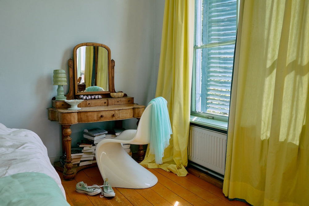 HKLIVING petal green ribbed ceramic table lamp styled beside a Panton chair in a bedroom with yellow curtains