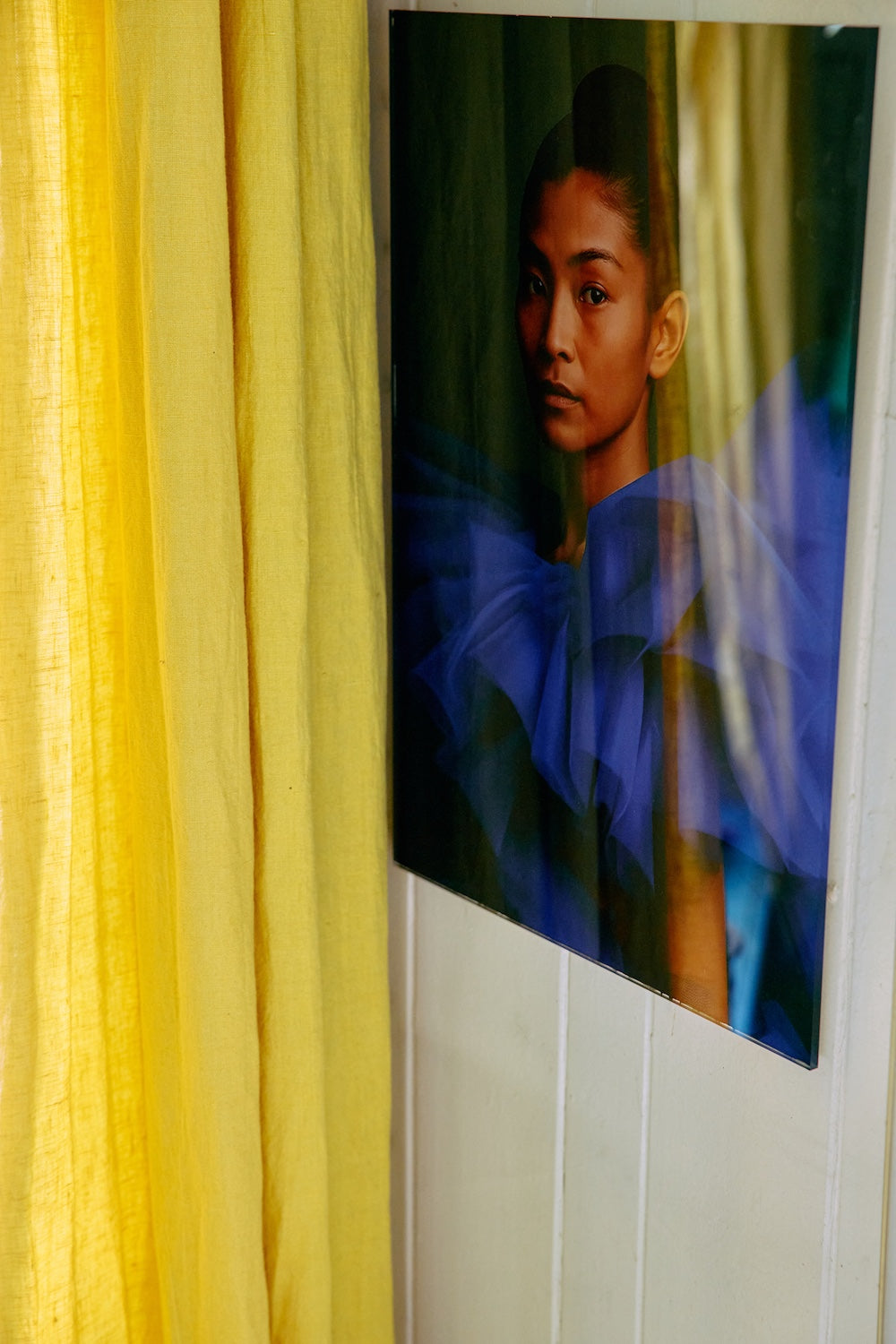 Volt plexi portrait by HKLIVING hung against a wall beside a yellow curtain