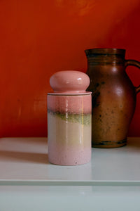 70s Ceramics storage jar in Glaze by HKLIVING styled beside a rustic stoneware pitcher on a shelf against an orange wall