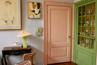 Sage green Levels wall sculpture styled near a pink painted doorway