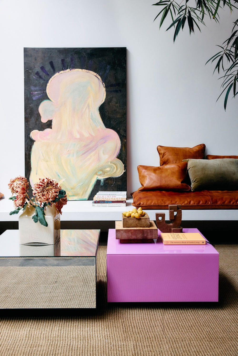 Pappagallo wall art by Gabriella Ferrero for HKLIVING leaning against a wall beside a leather sofa and dried flowers