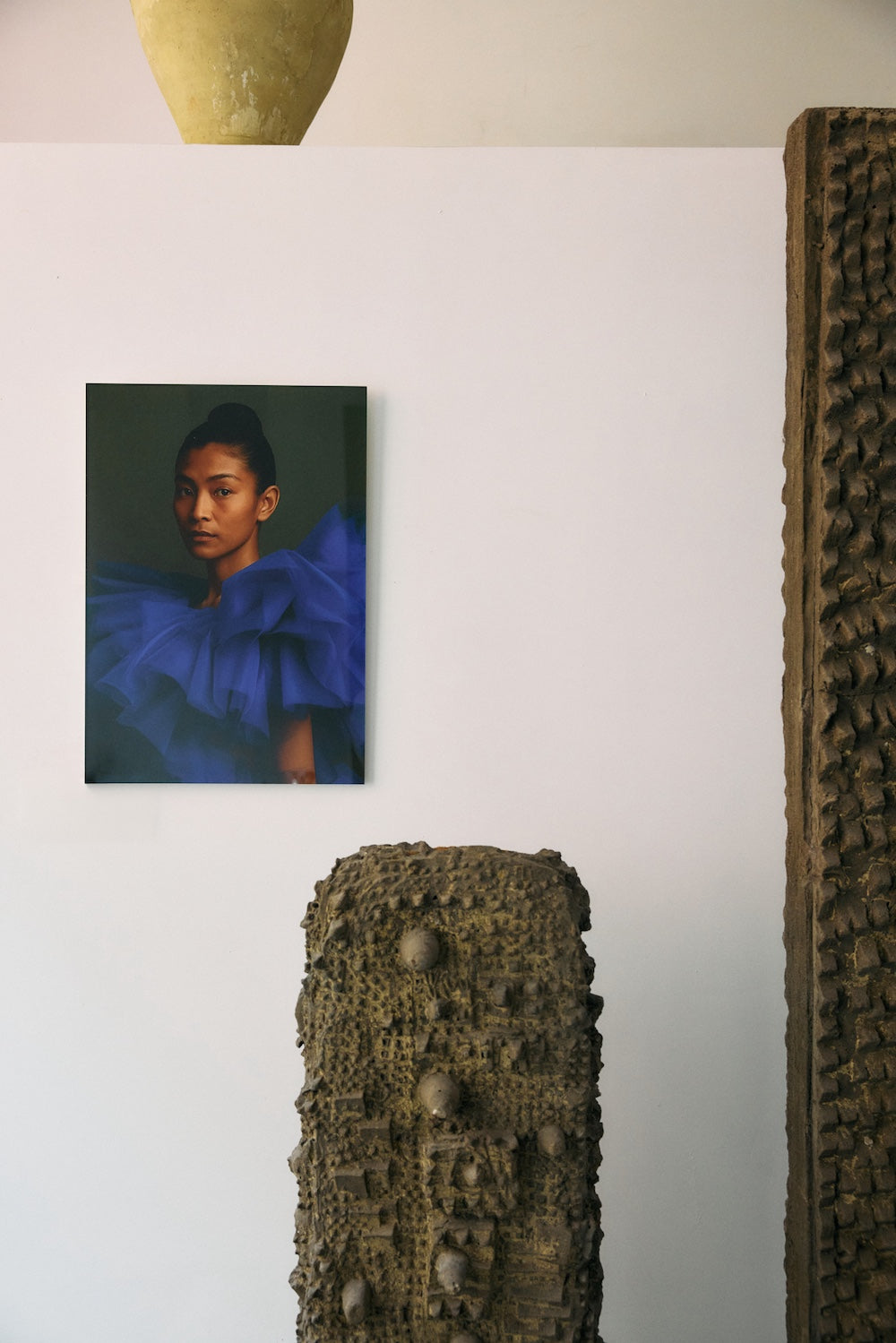 Volt plexi portrait by HKLIVING displayed on a shelf beneath a ceramic vase and beside a sculptural totem