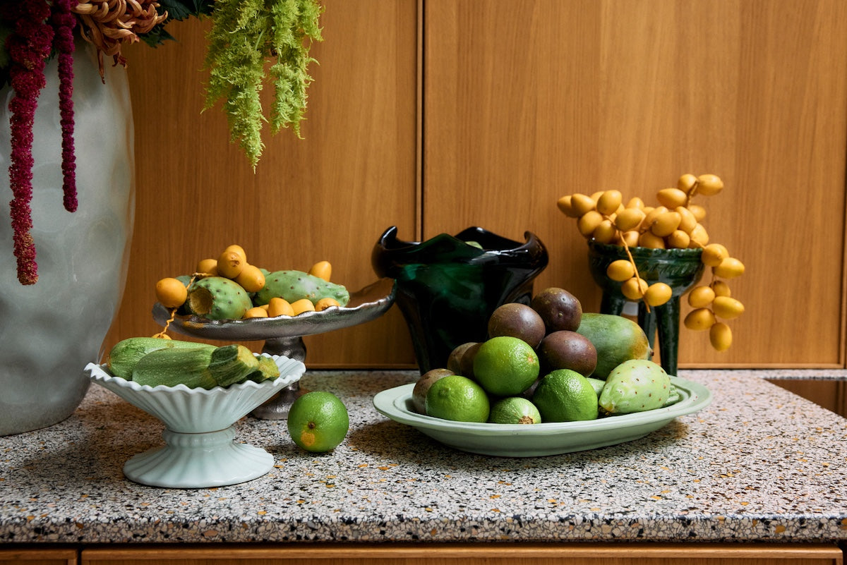 HKLIVING emerald green folded vase displayed on a wooden cabinet with fruit, dried flowers and ceramic dishes