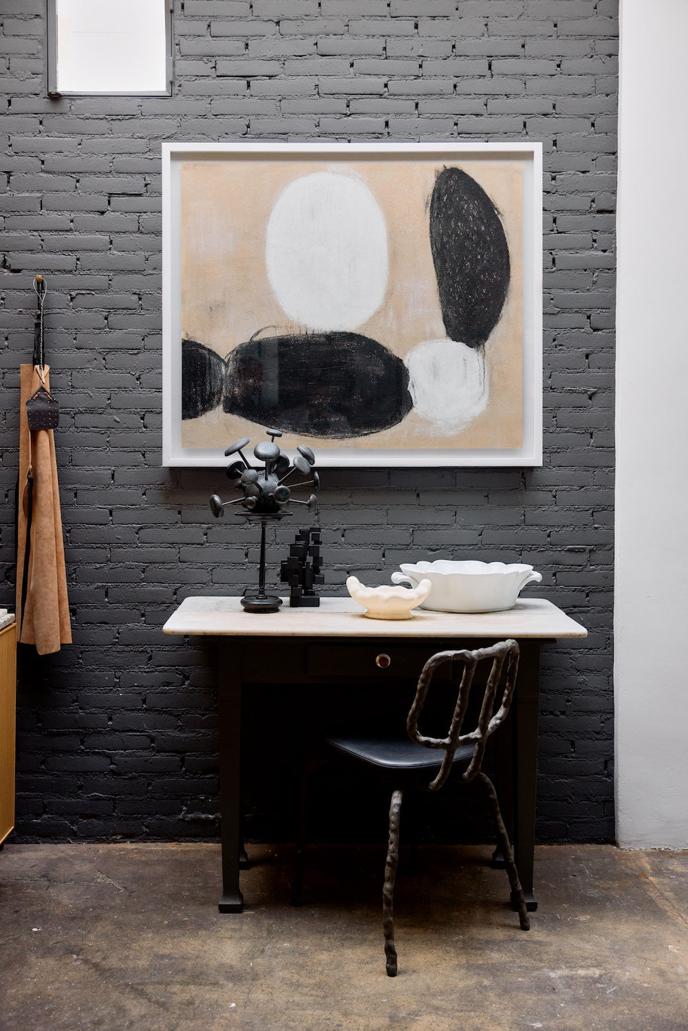 Parallel framed artwork by HKLIVING hung on a charcoal brick wall above a desk and chair