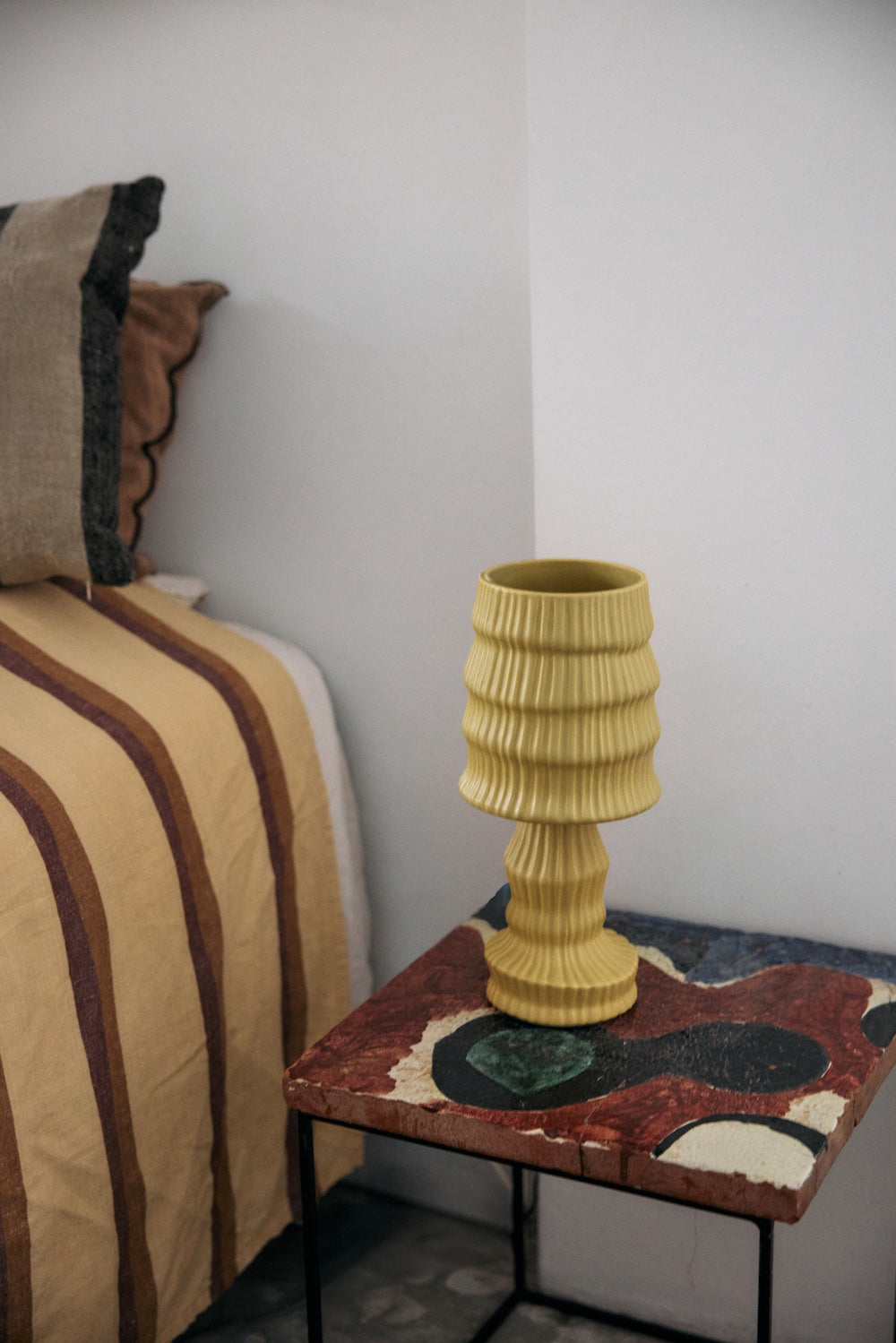 HKLIVING ochre ribbed ceramic table lamp styled on a mosaic tiled bedside table beside a striped bedspread