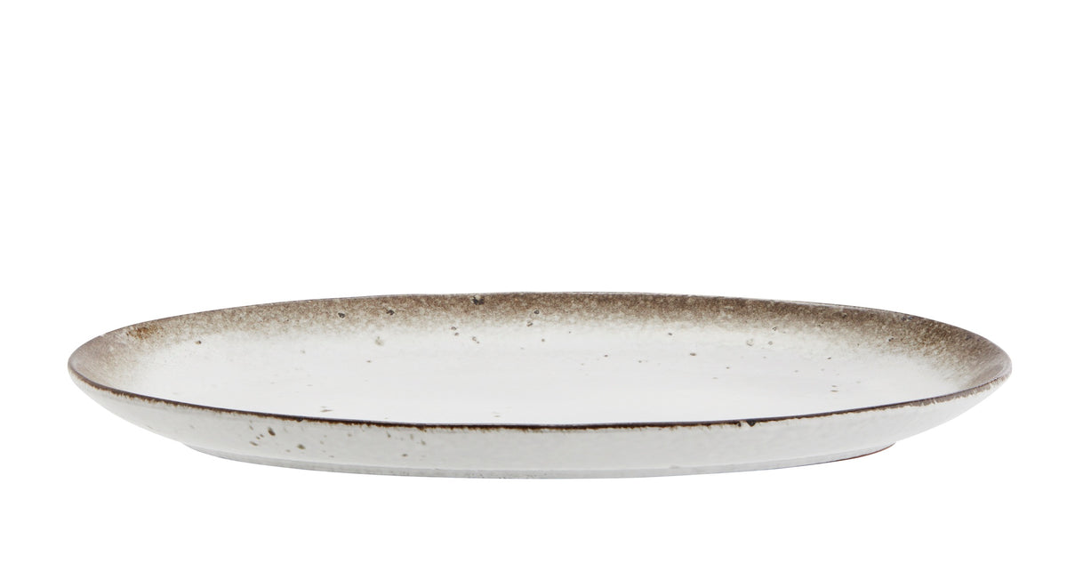 oval ceramic serving dish showing shallow profile and reactive glaze edge
