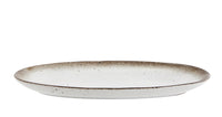 oval ceramic serving dish showing shallow profile and reactive glaze edge
