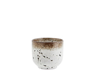 white and brown reactive glaze stoneware cup with speckled finish
