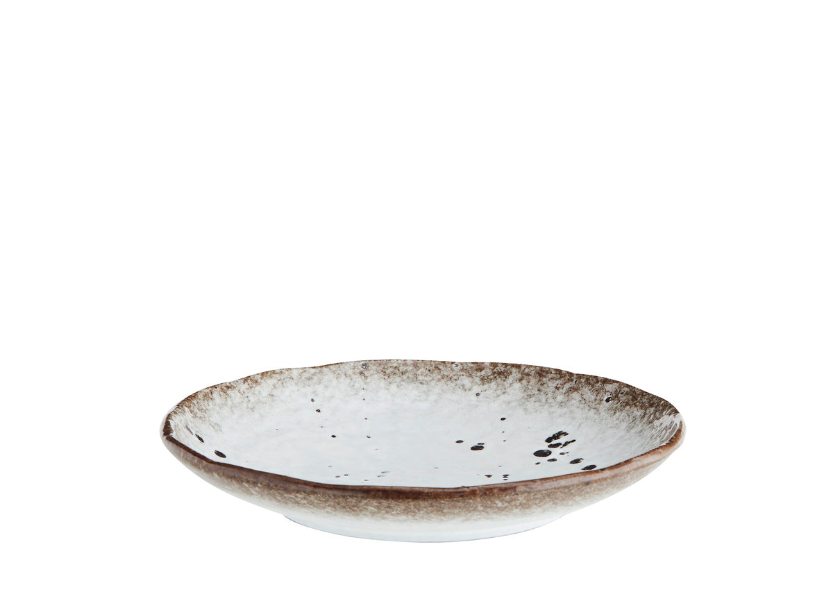 side view of speckled stoneware cake plate showing reactive glaze edge
