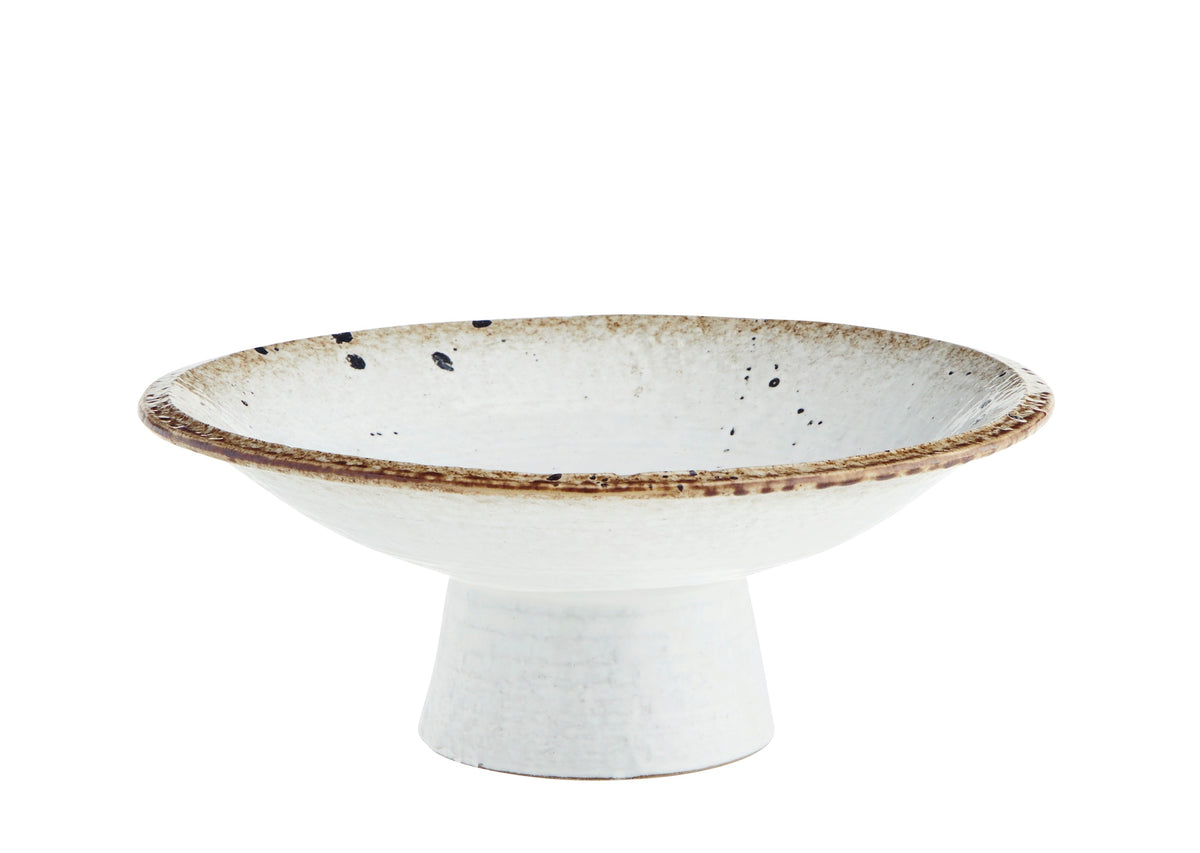 beige and brown speckled stoneware pedestal dish with reactive glaze finish
