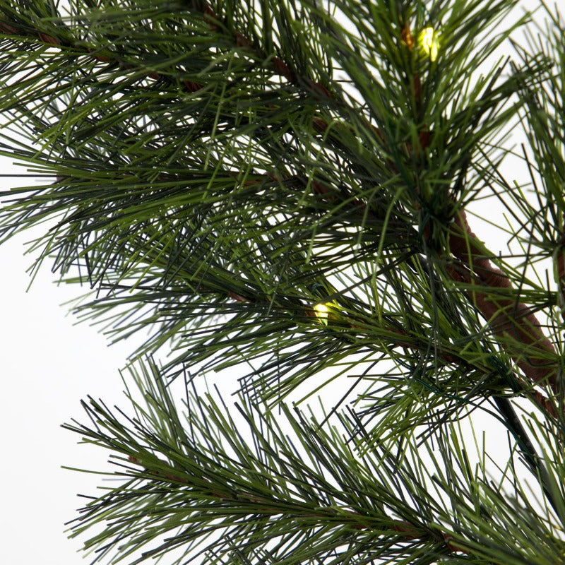 close up of the garland showing a pine needles and a cople of the small LED lights