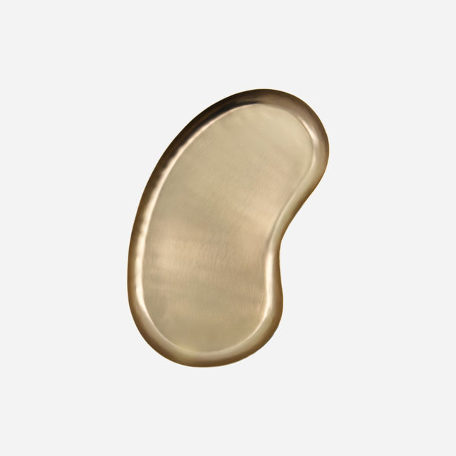 shiney brass tray in a kidney shape with a slight curved up edge to help retain articles from dutch brand house doctor