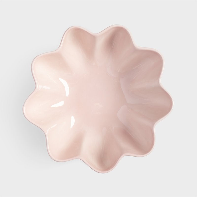 top view of pink wavy stoneware bowl showing sculptural sunburst shape
