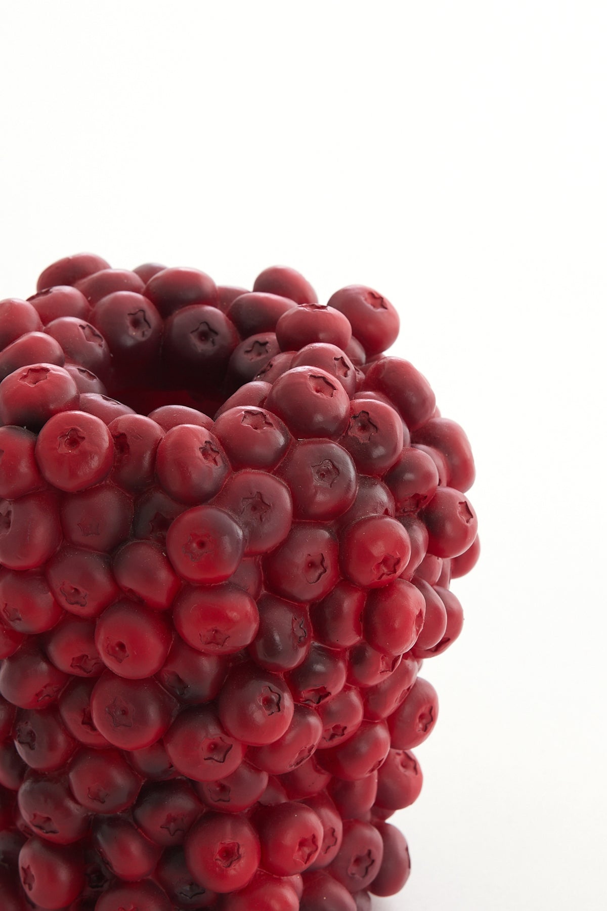 close-up of burgundy berries decorative vase showing sculptural clustered texture
