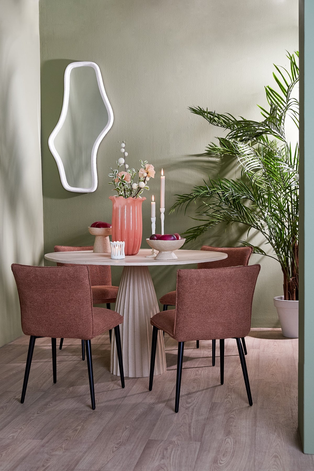 peach sedona glass vase styled on dining table with soft green walls