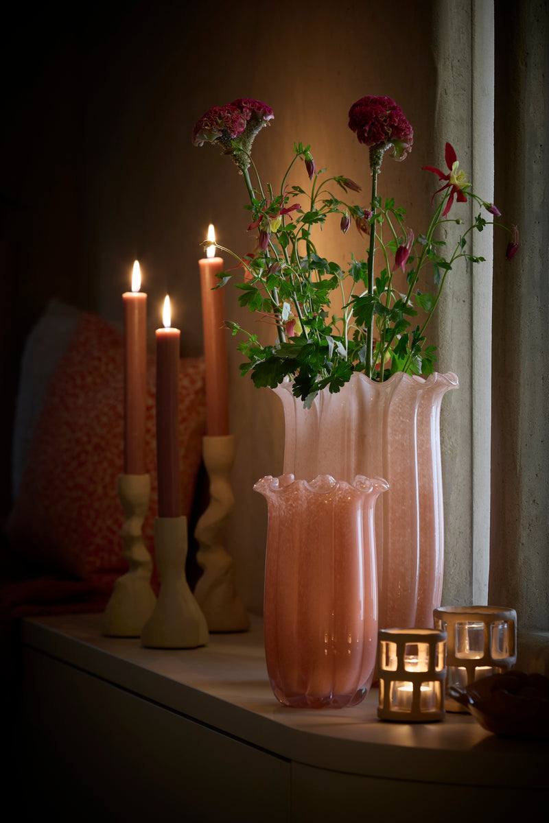 peach sedona vase with flowers styled on cabinet with candles