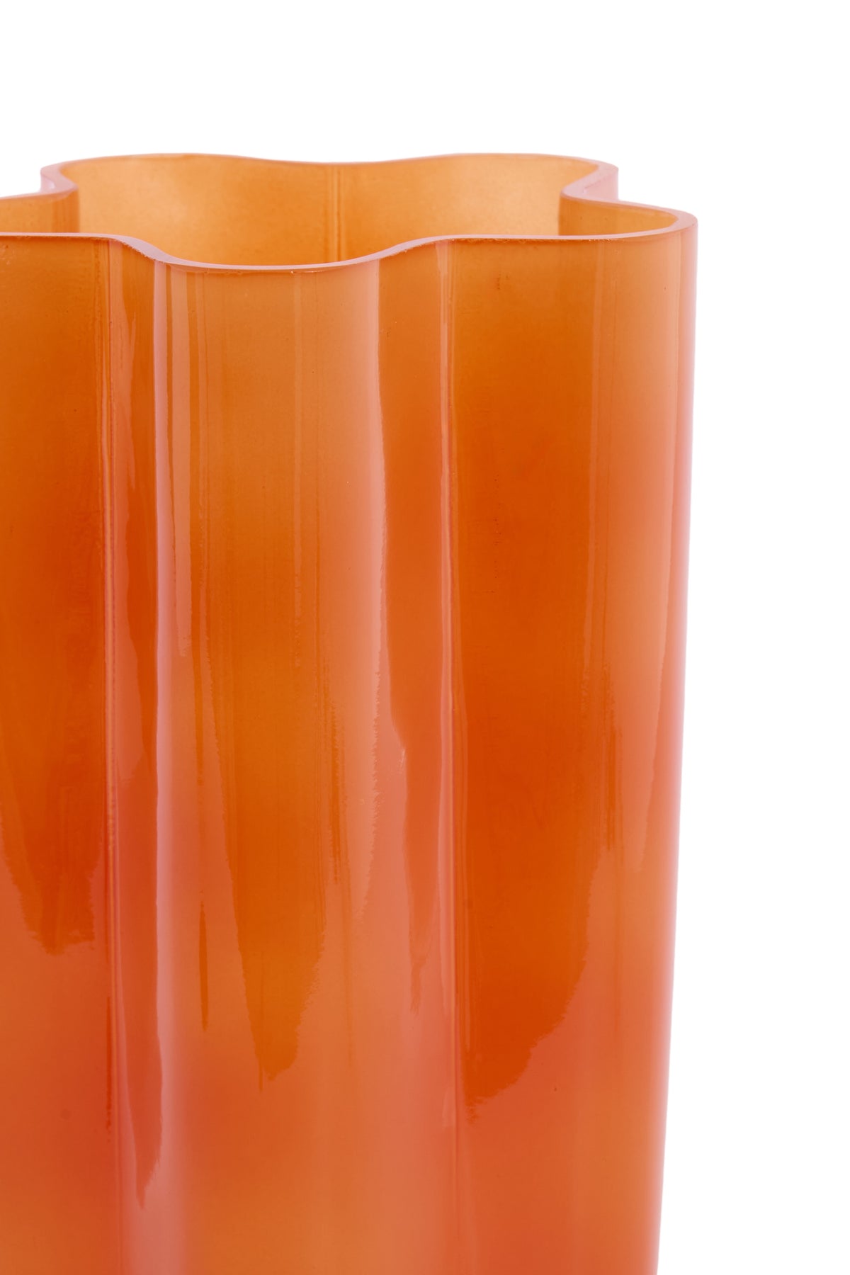 close-up of wavy orange glass vase rim showing glossy retro finish
