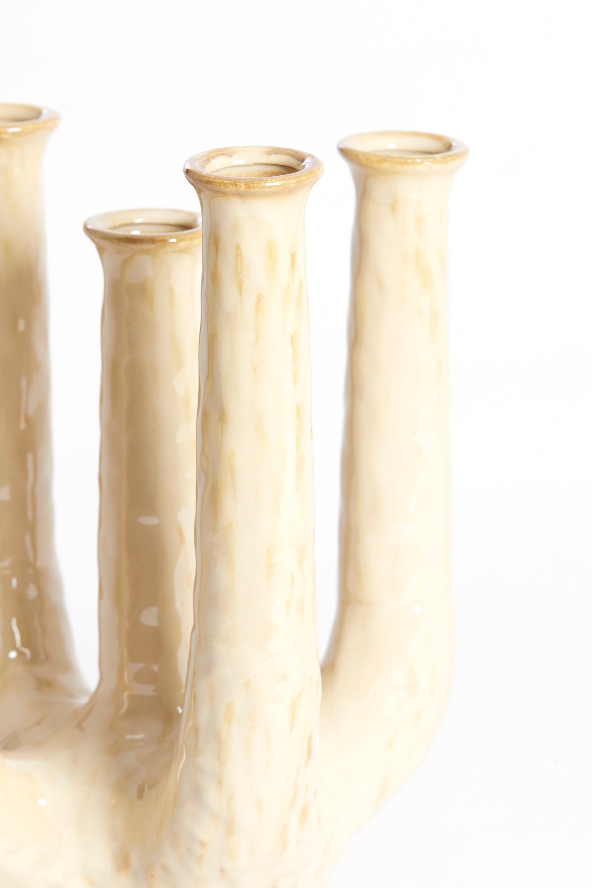 close-up of sand-beige sculptural ceramic vase with glossy textured finish