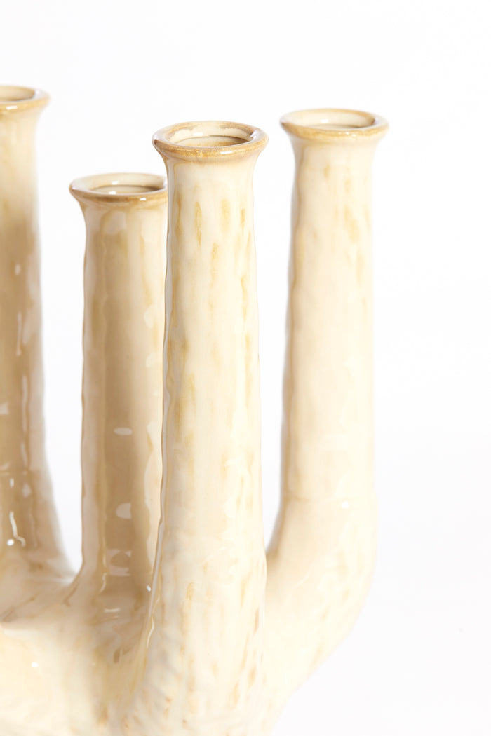 close-up of sand-beige sculptural ceramic vase with glossy textured finish