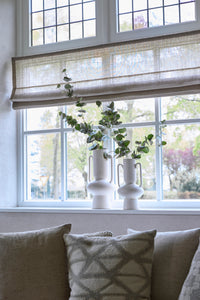 pair of cream sculptural OTARU vases styled on a windowsill with eucalyptus stems
